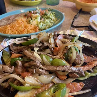 a plate of beef and peppers