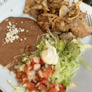 Pork carnitas, no rice with refried beans.