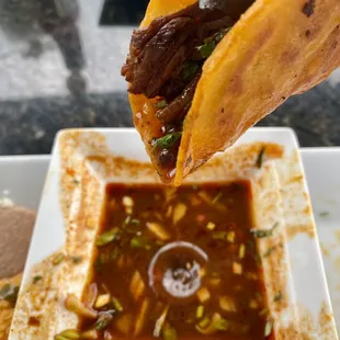 Birria Taco dipped in Consommé
