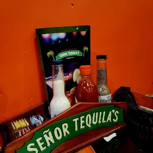 a bar with a menu and a bottle of tequila
