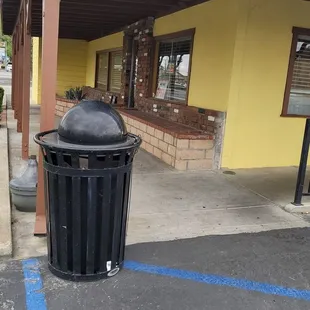 a trash can in a parking lot
