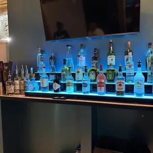 a row of liquor bottles on a bar