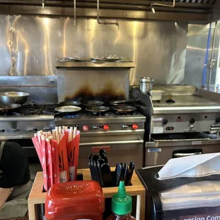 a kitchen counter with a variety of condiments