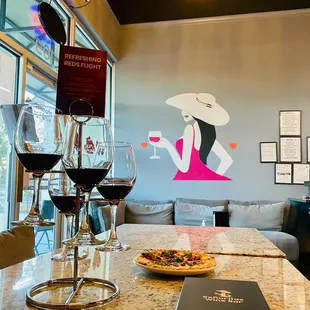 a glass of wine and a plate of pizza