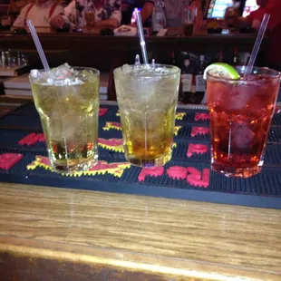 three different types of cocktails on a bar