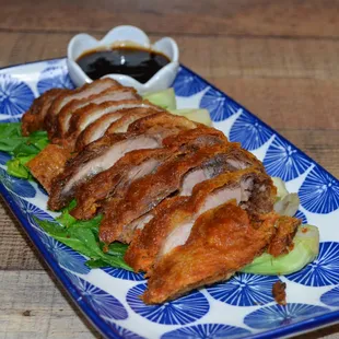 Ped Tod Krob: Crispy duck served on a bed of steamed mixed vegetables, with a house-made sweet and sour sauce.