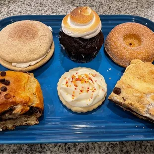 Snickerdoodle whoopie pie, s'mores cupcake, apple cider donut, chocolate brioche roll, frosted sugar cookie, s'mores bar.