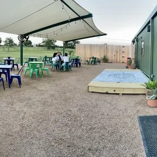 Backyard with shade, seating, and a stage