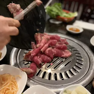 a person preparing food on a grill