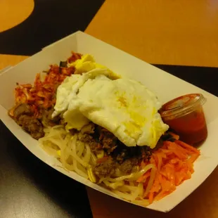 Bibimbap as it comes. Meat of your choice (Beef), Rice, Kimchi, Cucumber, Carrot, Bean Sprouts, and Spicy Gochujang sauce on the side