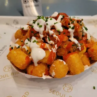K-Tots ($8 - Tater tots topped with melted cheese, kimchi, hot sauce, sour cream, pico de gallo, and chives).