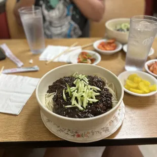 a bowl of noodles and vegetables on a table
