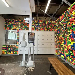 a brightly colored wall and a bench