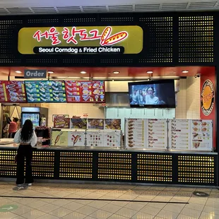 people standing in front of a food stand