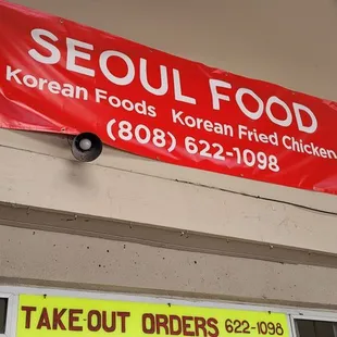a red banner hanging from the side of a building