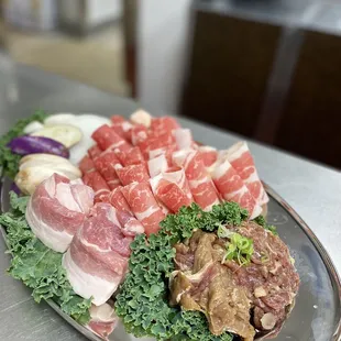 a platter of meat and vegetables