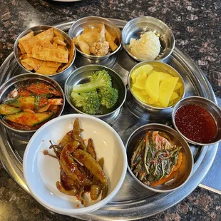 a variety of dishes on a silver tray