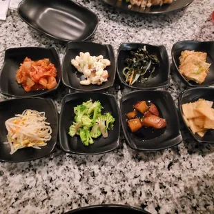 Banchan (side dishes) Kimchi,  bean sprouts, macaroni salad, broccoli, soy garlic potatoes, spinach, tofu