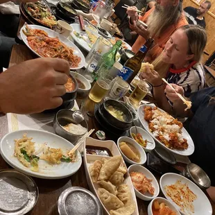 a table full of food and people eating