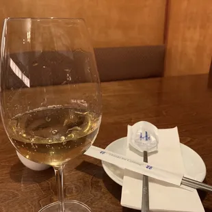 Glass of house white; nice presentation of metal chopsticks with sanitized spoon. Old school feel here with COVID precaution.