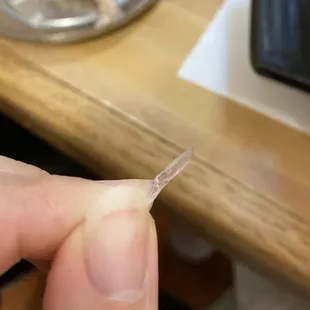 a person holding a piece of plastic