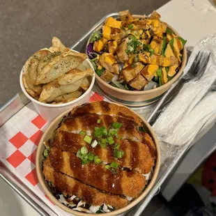 two bowls of food on a tray
