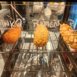 a variety of donuts in a display case