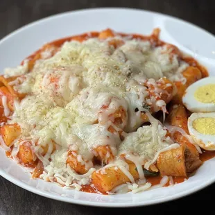 a plate of pasta with hard boiled eggs