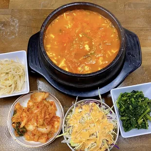 Spicy tofu soup with side dishes.