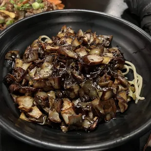 a bowl of noodles and mushrooms