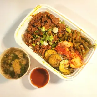 Spicy pork on greens with cucumber, kimchi, and green beans, beef bone broth and Seoul Spicy sauce - just excellent!!