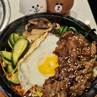 Beef bugogi (in a stone pot) on a bed of rice