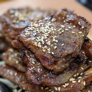 a plate of beef with sesame seeds