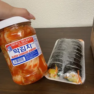 fresh kimchi and fresh kimbap ( fish cake, pickled radish, carrots, egg, &amp; rice )