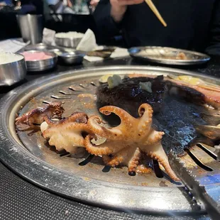 an octopus on a plate with chopsticks