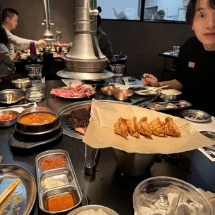 a woman sitting at a table with food