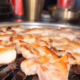 a close up of a grill with a lot of food on it