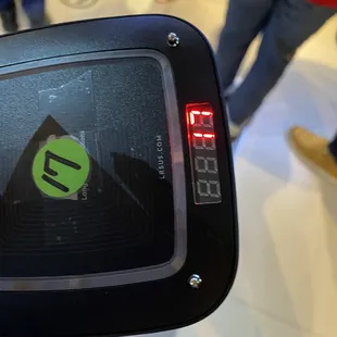 a person holding a cell phone with a green sticker on it