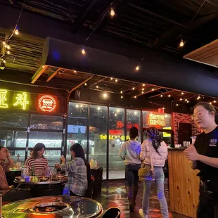 a group of people eating at a restaurant