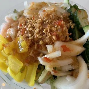 Poke bowl with spicy crab &amp; shrimp with pickled radish, cucumbers, onions and daikon radish. Topped with fried garlic &amp; mango chili sauce.