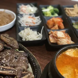 Short rib/kalbi combo dinner with all the great accompaniments including kimchi, radish, cucumbers, and more.