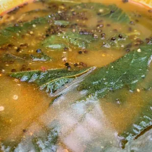 a bowl of soup with greens