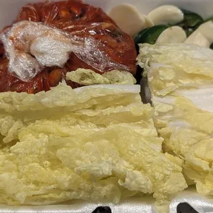 a variety of vegetables in a styrofoam container