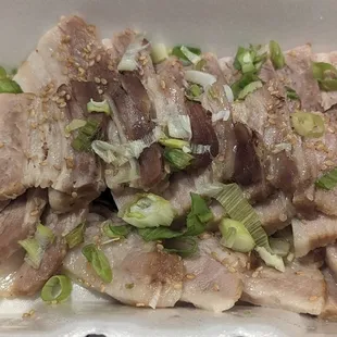 a close - up of the meat in a styrofoam container