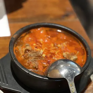 a bowl of soup and a spoon