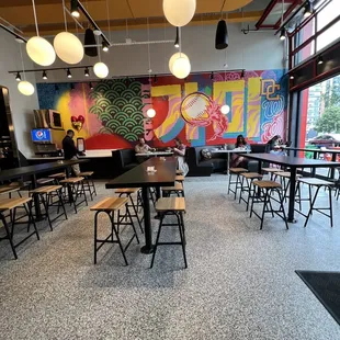 tables and chairs in a brightly decorated restaurant