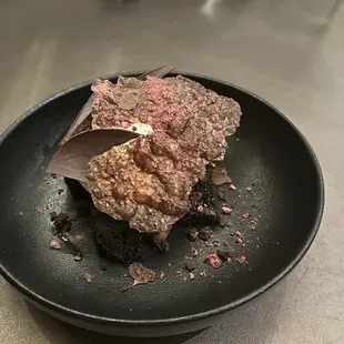 a chocolate dessert on a black plate