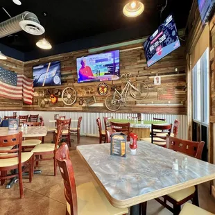 Dining space with televisions above.