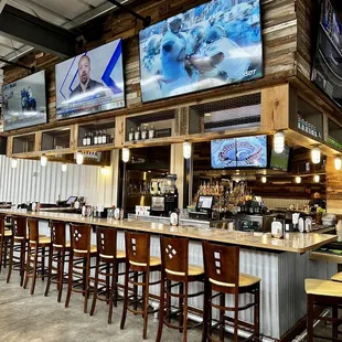 Large bar area, part indoors, other part goes outside , lots of TV's.
