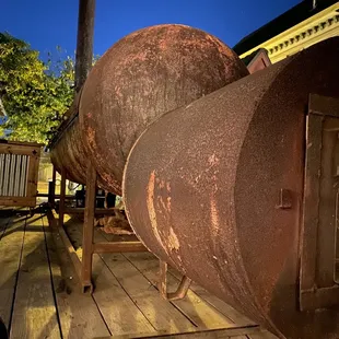 an old rusted barrel on a wooden deck